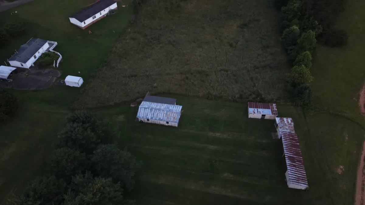 Aerial drone shot of old tin-roof barns in the North Carolina countryside