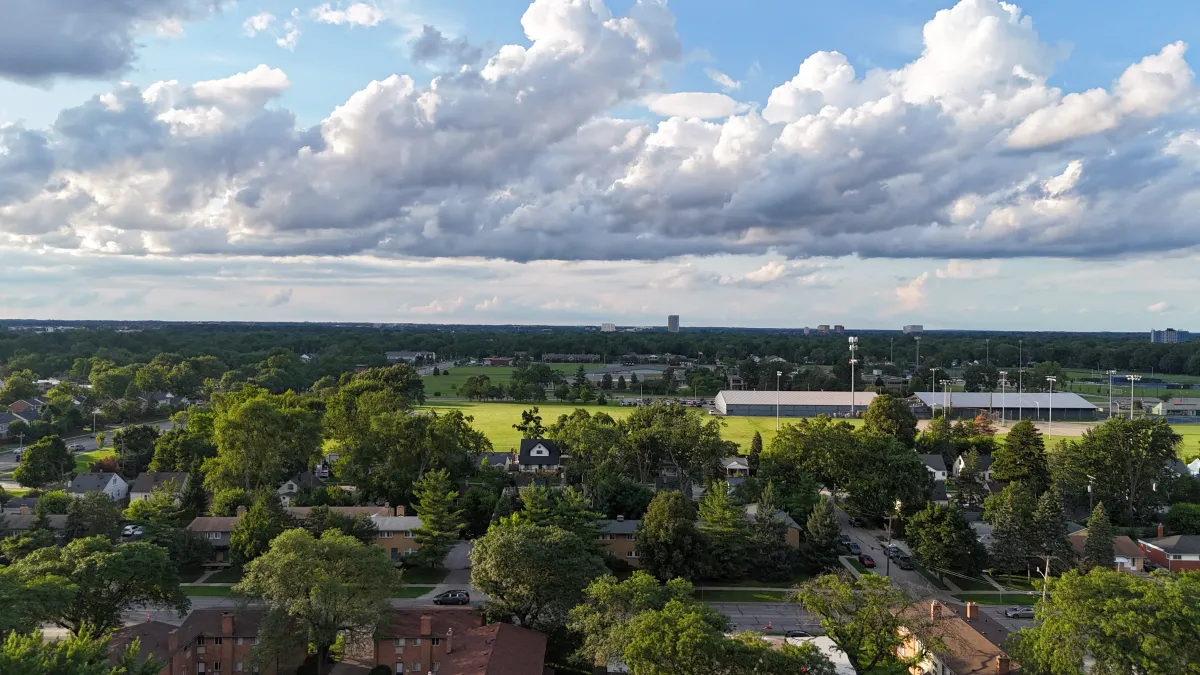 Aerial drone shot of a metro Detroit suburb with ball fields and water tower